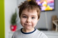 Portrait of a smiling, pretty boy of several years in the children room.