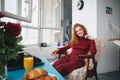 Portrait of a smiling pretty girl sitting on a chair Royalty Free Stock Photo