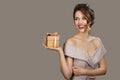 Portrait of smiling pretty woman holding a gift box in hands. Royalty Free Stock Photo