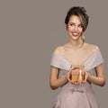Portrait of smiling pretty woman holding a gift box in hands. Royalty Free Stock Photo