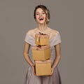 Portrait of smiling pretty woman holding a gift boxes in hands. Royalty Free Stock Photo