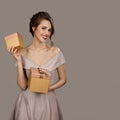 Portrait of smiling pretty woman holding a gift boxes in hands. Royalty Free Stock Photo