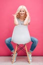 Portrait of a smiling pretty woman sitting on the chair Royalty Free Stock Photo