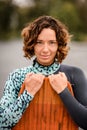 portrait of smiling pretty woman who is holding wakeboarding board by her hands. Royalty Free Stock Photo