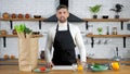 Portrait smiling professional chef man in apron looking camera in home kitchen Royalty Free Stock Photo