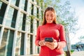 Portrait of smiling real young woman using mobile phone app , texting, playing game, shopping online, ordering delivery Royalty Free Stock Photo