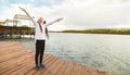 Portrait of a smiling relaxed little girl walking along the embankment of the river in the rain Royalty Free Stock Photo