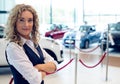 Portrait of smiling saleswoman standing in showroom