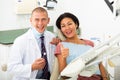 Satisfied patient visiting dentist giving thumbs up Royalty Free Stock Photo