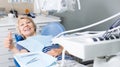 Satisfied woman visiting dentist giving thumbs up Royalty Free Stock Photo