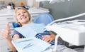 Satisfied woman visiting dentist giving thumbs up Royalty Free Stock Photo