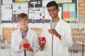 Portrait of smiling school kids doing a chemical experiment in laboratory Royalty Free Stock Photo
