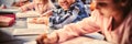 Portrait of smiling schoolboy doing his homework in classroom Royalty Free Stock Photo