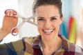 Portrait of smiling seamstress showing scissors Royalty Free Stock Photo