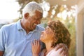 Portrait Of Smiling Senior African American Couple In Garden At Home