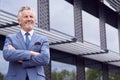 Portrait Of Smiling Senior Businessman CEO Chairman Standing Outside Modern Office Building Royalty Free Stock Photo