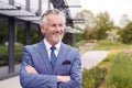 Portrait Of Smiling Senior Businessman CEO Chairman Standing Outside Modern Office Building Royalty Free Stock Photo