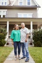 Portrait Of Smiling Senior Couple In Front Of Their Home Royalty Free Stock Photo
