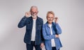 Portrait of smiling senior couple looking out through eyeglasses while standing on white background Royalty Free Stock Photo