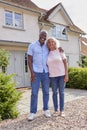 Portrait Of Smiling Senior Couple Standing Outside Home Together Royalty Free Stock Photo