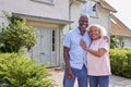 Portrait Of Smiling Senior Couple Standing Outside Home Together Royalty Free Stock Photo