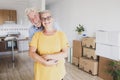 Portrait of a smiling senior couple with white hair embraced during relocation,  happy for the new beginning like retired with Royalty Free Stock Photo