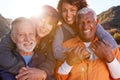 Portrait Of Smiling Senior Friends Having Fun Walking In Countryside Together