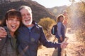 Portrait Of Smiling Senior Friends Hiking In Along Trail Countryside Together Royalty Free Stock Photo