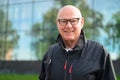 Portrait of a smiling senior man in front of a modern building Royalty Free Stock Photo