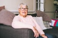 Portrait of smiling senior, mature retired grandmother in eyeglasses, elderly woman smiling sitting on sofa at home Royalty Free Stock Photo