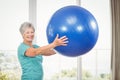 Portrait of smiling senior woman holding exercise ball Royalty Free Stock Photo