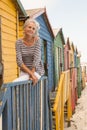 Portrait smiling senior woman sitting on railing Royalty Free Stock Photo