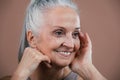 Portrait of smiling senior woman in studio. Royalty Free Stock Photo