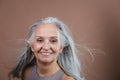 Portrait of smiling senior woman in studio. Royalty Free Stock Photo