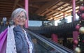 Portrait of a smiling senior woman white haired doing shopping for christmas in a mall, while holding many bags with gifts for Royalty Free Stock Photo