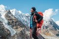 Portrait of smiling Sherpa man with backpack enjoying mountain views and fresh air with Mera peak 6476m background. High Himalayas