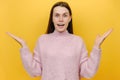 Portrait of smiling shocked surprised wondered attractive beautiful young woman wearing pink knitted sweater looking camera Royalty Free Stock Photo