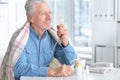 Portrait of smiling sick senior man with inhaler