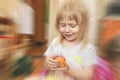 Portrait of smiling small girl. Child is happy because she likes sculpt out of play clay, play doh. Children development concept. Royalty Free Stock Photo