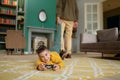 Portrait of smiling son playing video game while father pulling him out Royalty Free Stock Photo