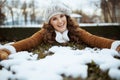 Smiling stylish female outdoors in city park in winter playing