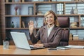 Portrait of a smiling and successful senior business woman working in the office with a laptop, wearing a headset Royalty Free Stock Photo