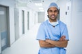 Portrait of smiling surgeon standing in corridor Royalty Free Stock Photo