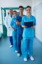 Portrait of smiling surgeons and doctors standing in corridor Royalty Free Stock Photo