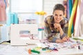 Portrait of smiling tailor near sewing machine Royalty Free Stock Photo