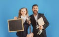 Portrait of smiling teacher and happy pupil schoolgirl ready to school. Portrait of dad and little girls with school Royalty Free Stock Photo