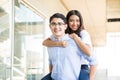 Boy Piggybacking Girlfriend In Shopping Mall