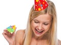 Portrait of smiling teenage girl in cap with party horn blower Royalty Free Stock Photo