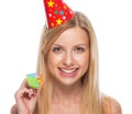 Portrait of smiling teenage girl in cap party horn blower Royalty Free Stock Photo