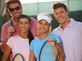 Portrait of smiling tennis team